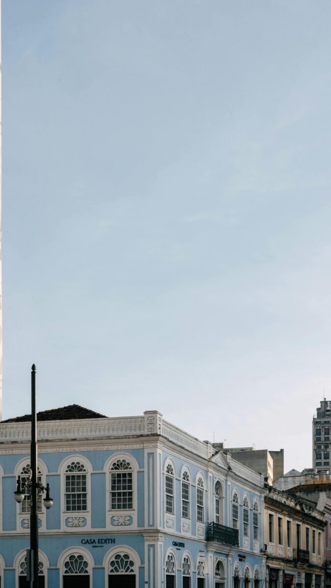 Charming historic architecture with a blue facade under clear skies in Curitiba, Brazil.